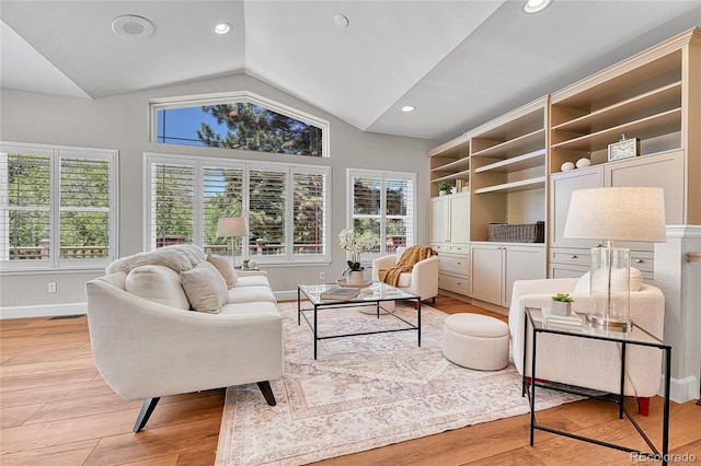living room featuring vaulted ceiling, light wood-style flooring, plenty of natural light, baseboards, and recessed lighting
