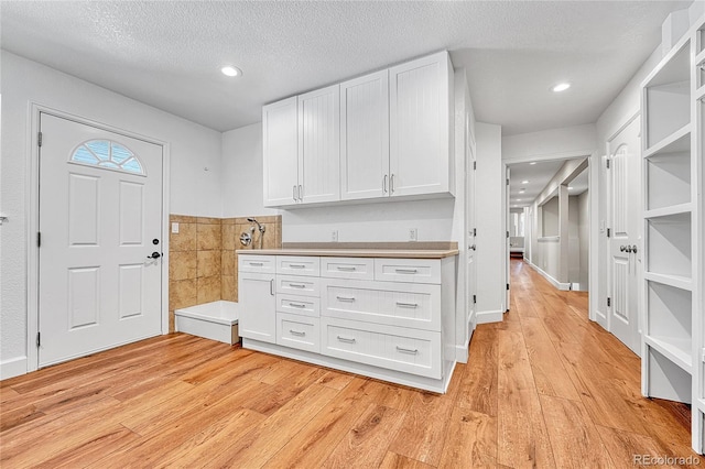 entryway featuring light wood finished floors, recessed lighting, and a textured ceiling