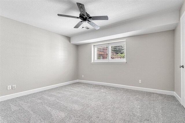 carpeted empty room featuring baseboards, a textured ceiling, and ceiling fan