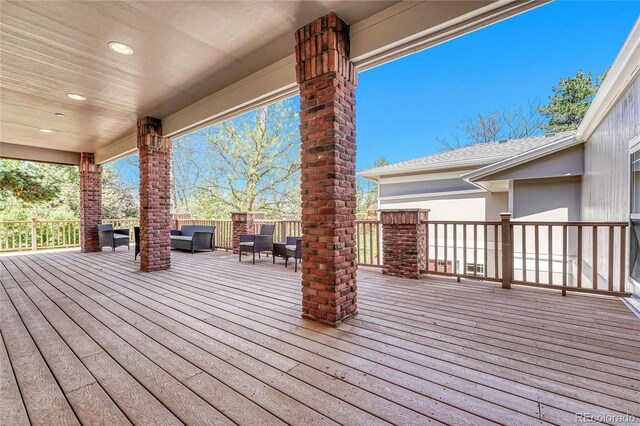wooden deck featuring an outdoor living space