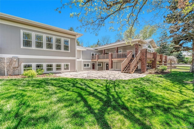 rear view of property with a patio area, stairs, a yard, and a wooden deck
