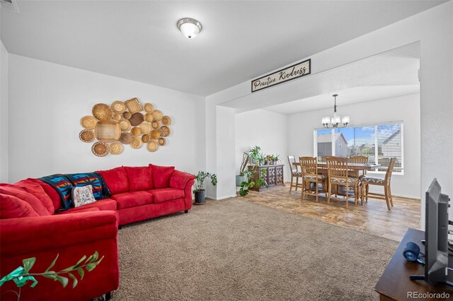 living room with a notable chandelier and carpet flooring