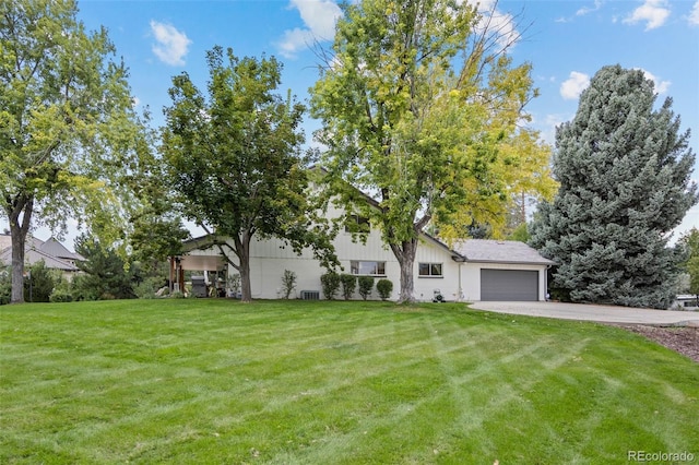 view of front facade with a front yard and a garage