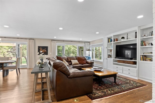 living room with baseboard heating and hardwood / wood-style floors