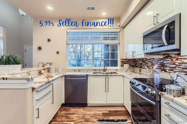 kitchen featuring white cabinetry, double oven range, sink, and dishwashing machine