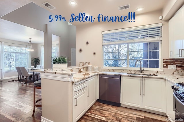 kitchen featuring sink, white cabinets, light stone counters, kitchen peninsula, and stainless steel appliances