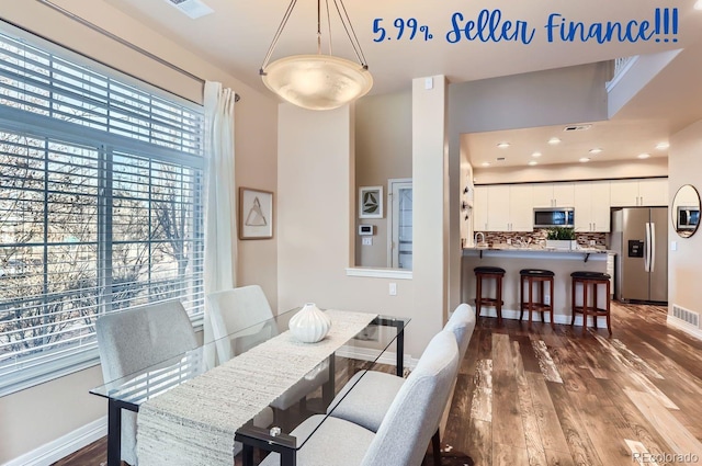 dining space with dark wood-type flooring