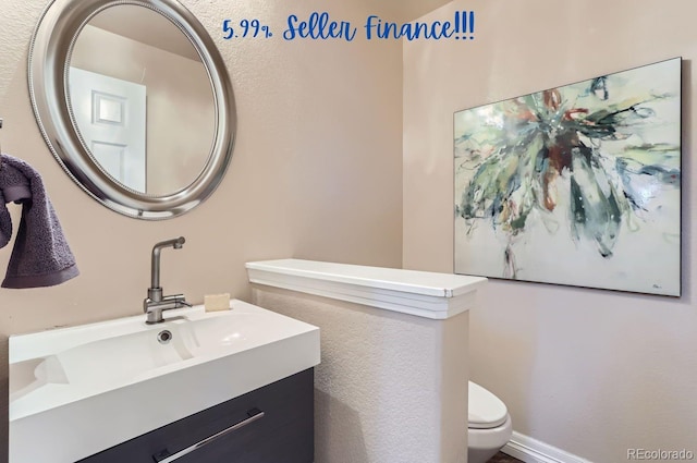 bathroom featuring vanity and toilet