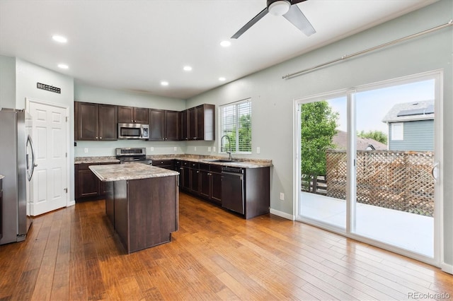 5021 S Rome St, Aurora, CO 80015 - kitchen with appliances with stainless steel finishes, a sink, dark brown cabinetry, hardwood / wood-style flooring, and ceiling fan