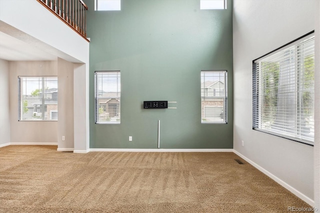5021 S Rome St, Aurora, CO 80015 - carpeted spare room with a towering ceiling and baseboards