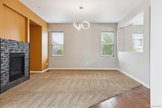 5021 S Rome St, Aurora, CO 80015 - unfurnished living room featuring plenty of natural light, baseboards, and a glass covered fireplace