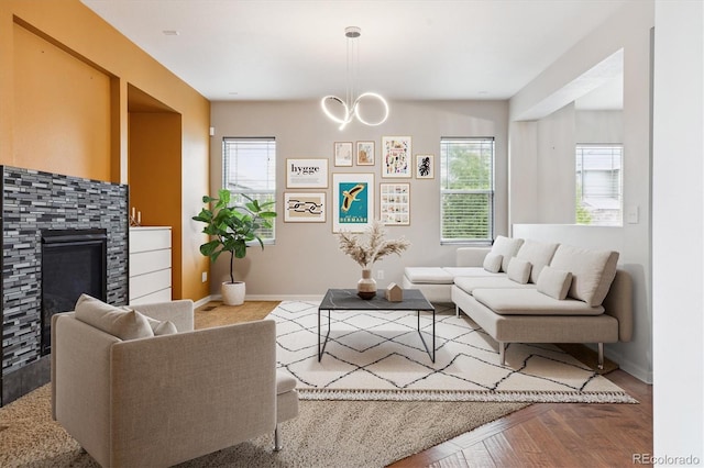 5021 S Rome St, Aurora, CO 80015 - living room featuring plenty of natural light, baseboards, a glass covered fireplace, and a chandelier