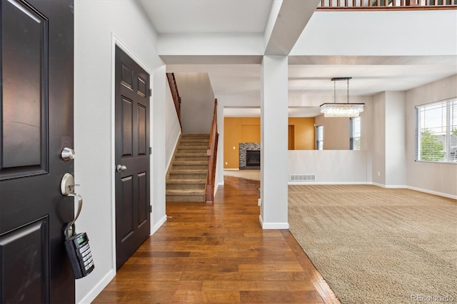5021 S Rome St, Aurora, CO 80015 - entrance foyer featuring stairway, wood finished floors, baseboards, and a chandelier