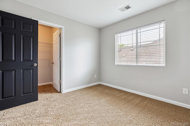 5021 S Rome St, Aurora, CO 80015 - unfurnished bedroom featuring carpet, a walk in closet, baseboards, and a closet