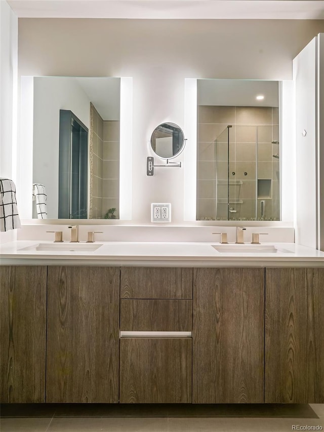 bathroom featuring tile patterned floors, a shower with door, and vanity