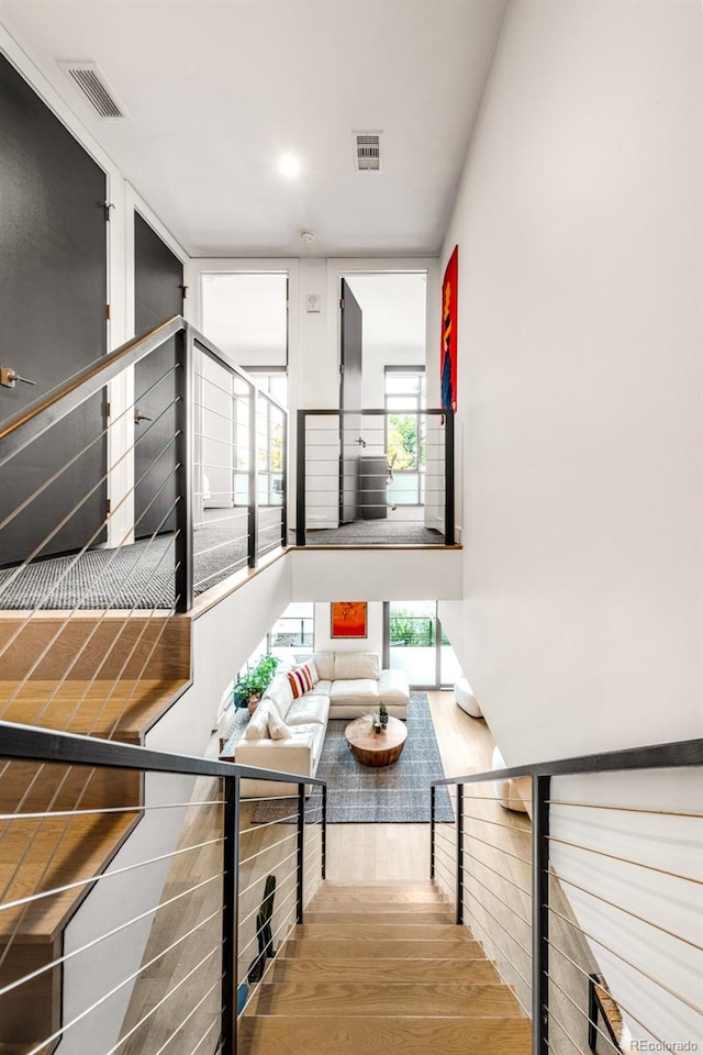 stairway with hardwood / wood-style floors