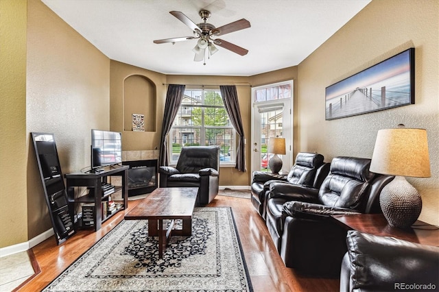 living room with hardwood / wood-style floors and ceiling fan