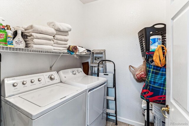 laundry room featuring separate washer and dryer and light tile patterned floors