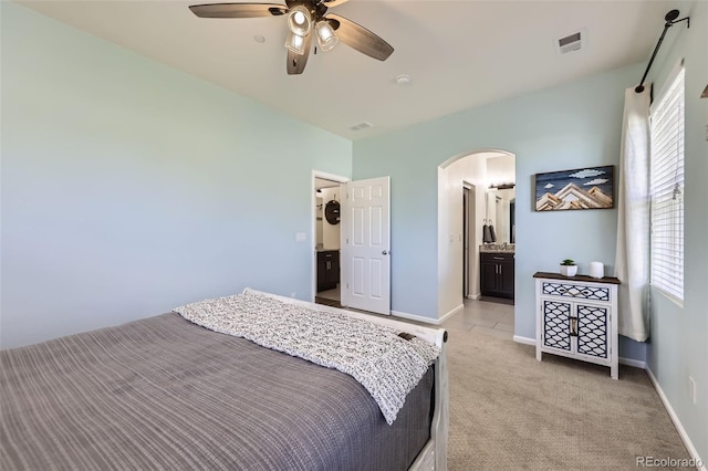 12910 Grant Cir W Unit C, Thornton, CO 80241 - bedroom with arched walkways, light colored carpet, multiple windows, and a ceiling fan