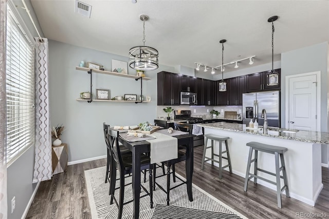 12910 Grant Cir W Unit C, Thornton, CO 80241 - dining room featuring dark wood finished floors, a chandelier, and rail lighting