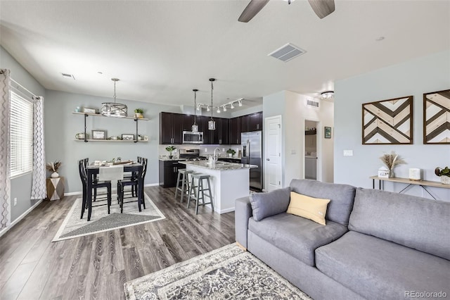 12910 Grant Cir W Unit C, Thornton, CO 80241 - living area with wood finished floors, rail lighting, and ceiling fan