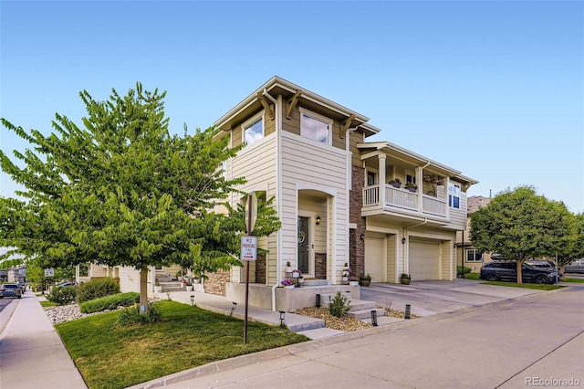 12910 Grant Cir W Unit C, Thornton, CO 80241 - view of front of house with an attached garage, driveway, stone siding, and a balcony