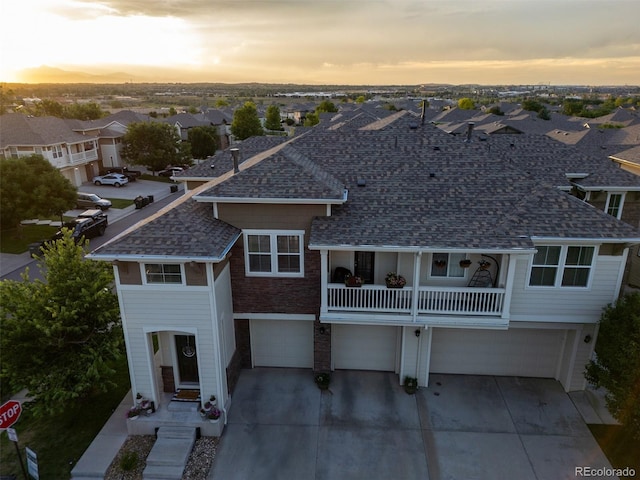 12910 Grant Cir W Unit C, Thornton, CO 80241 - view of front of property with a residential view, driveway, roof with shingles, and a garage