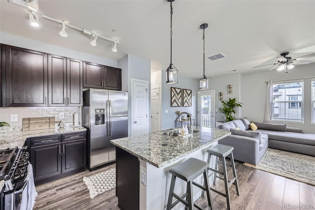 12910 Grant Cir W Unit C, Thornton, CO 80241 - kitchen with stainless steel appliances, open floor plan, wood finished floors, and healthy amount of natural light