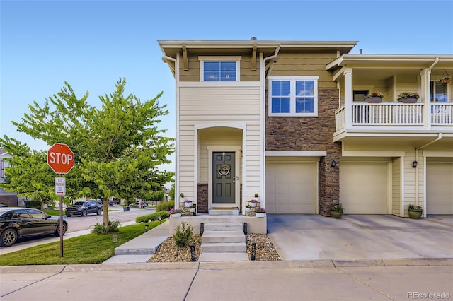 12910 Grant Cir W Unit C, Thornton, CO 80241 - view of front of home with stone siding, a garage, and driveway
