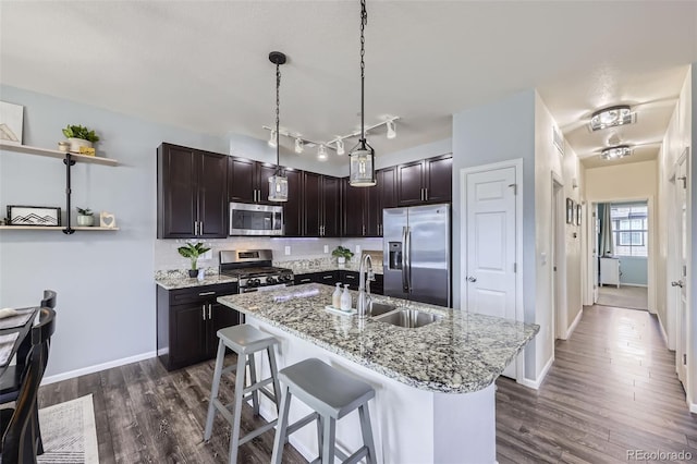 12910 Grant Cir W Unit C, Thornton, CO 80241 - kitchen with stainless steel appliances, dark wood-type flooring, a kitchen island with sink, and dark brown cabinets