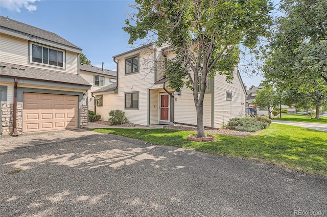 view of front of property with a front yard and a garage