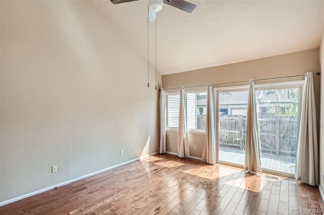 unfurnished room featuring light wood-type flooring, vaulted ceiling, and ceiling fan