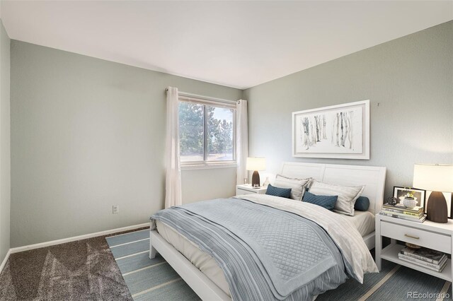 bedroom with dark colored carpet