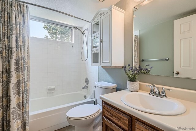 full bathroom with shower / tub combo, vanity, and toilet