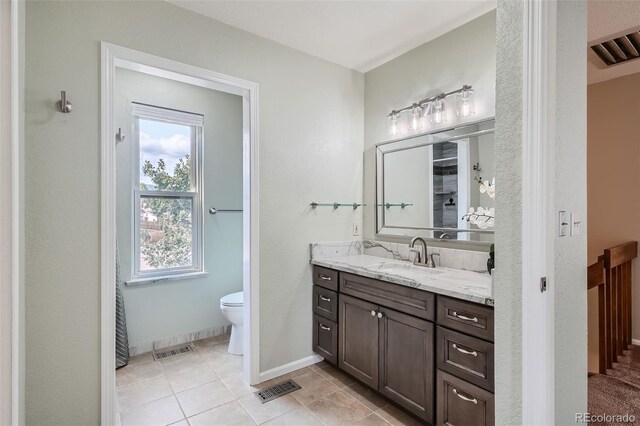 bathroom with tile patterned floors, vanity, and toilet