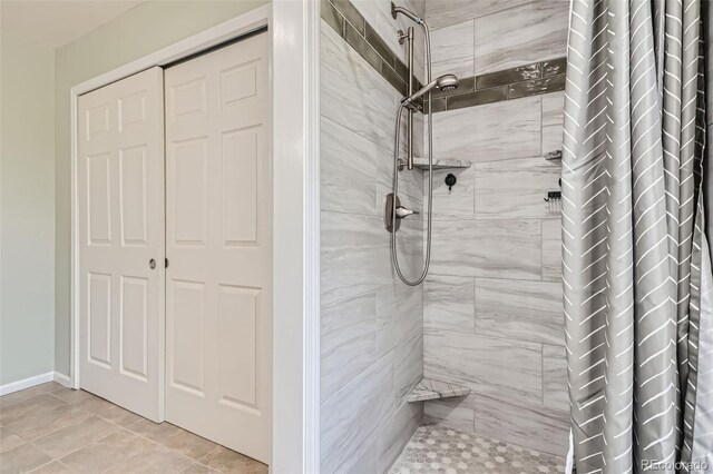 bathroom featuring tile patterned flooring and curtained shower