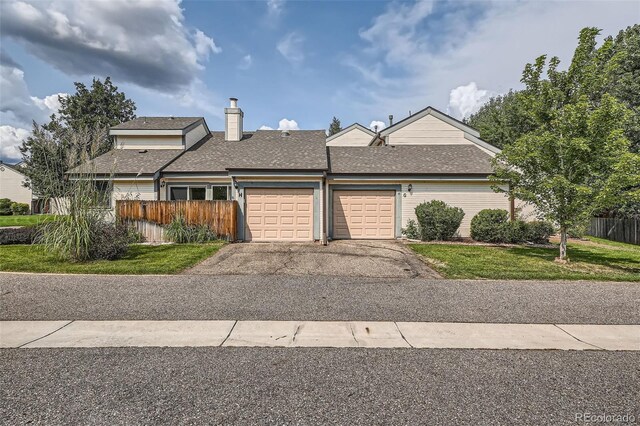 view of front of home featuring a garage and a front yard