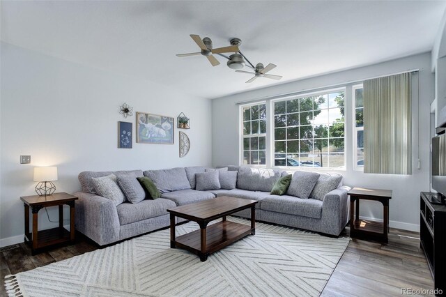 living room with dark hardwood / wood-style floors and ceiling fan