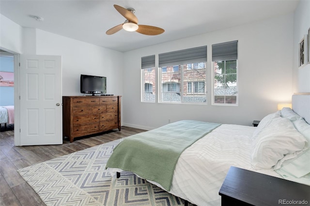 bedroom with wood-type flooring and ceiling fan