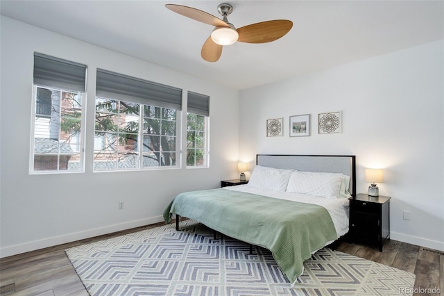 bedroom with wood-type flooring and ceiling fan