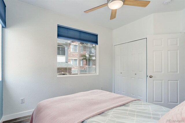 bedroom with hardwood / wood-style flooring, a closet, and ceiling fan