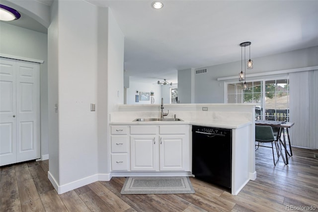 kitchen with black dishwasher, sink, white cabinets, hanging light fixtures, and kitchen peninsula