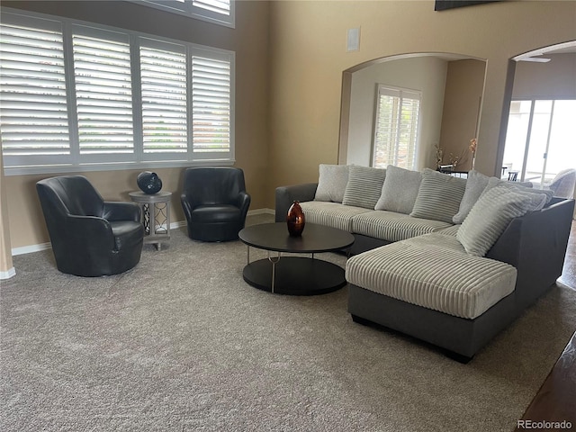 6405 Eagle Feather Trl, Littleton, CO 80125 - carpeted living room featuring arched walkways and healthy amount of natural light