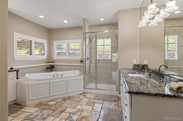 6405 Eagle Feather Trl, Littleton, CO 80125 - bathroom with a stall shower, vanity, stone tile flooring, a chandelier, and recessed lighting