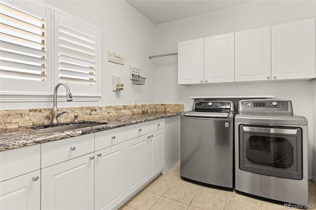 6405 Eagle Feather Trl, Littleton, CO 80125 - laundry room with washing machine and clothes dryer, cabinet space, and light tile patterned floors