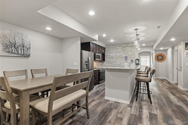 6405 Eagle Feather Trl, Littleton, CO 80125 - dining room with arched walkways, dark wood finished floors, and recessed lighting