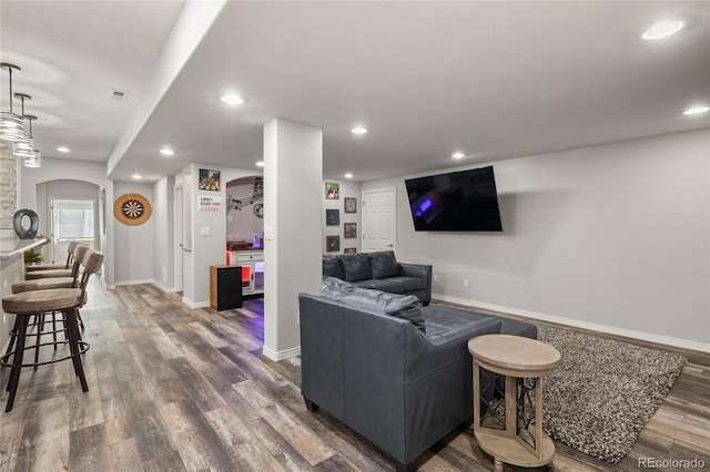 6405 Eagle Feather Trl, Littleton, CO 80125 - living area featuring dark wood-style floors, recessed lighting, baseboards, and arched walkways
