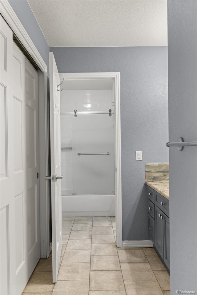 6405 Eagle Feather Trl, Littleton, CO 80125 - full bathroom with bathtub / shower combination, vanity, tile patterned floors, a textured ceiling, and a textured wall