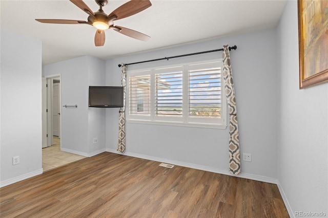 6405 Eagle Feather Trl, Littleton, CO 80125 - empty room with wood finished floors, ceiling fan, and baseboards