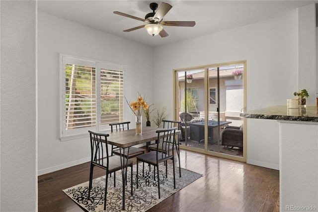 6405 Eagle Feather Trl, Littleton, CO 80125 - dining area featuring plenty of natural light, a ceiling fan, wood finished floors, and baseboards